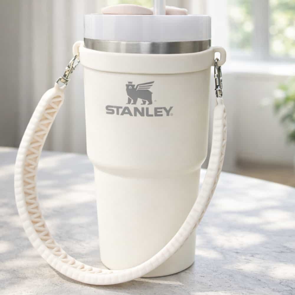 Cream-coloured Stanley insulated tumbler with carrying strap